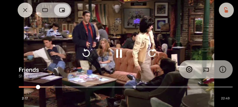The video player in landscape with on-screen controls over a playing episode.